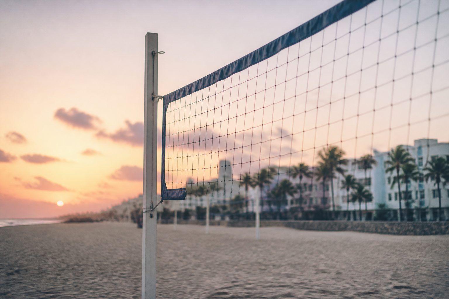 A beach volleyball net on Miami Beach at sunrise (AI-generated image)